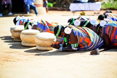 Tribal people sitting on field