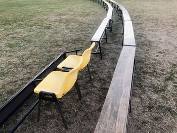 High angle view of empty chairs and tables arranged on field