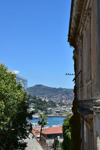 Buildings in city against clear sky