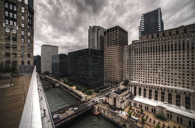 Modern buildings against cloudy sky