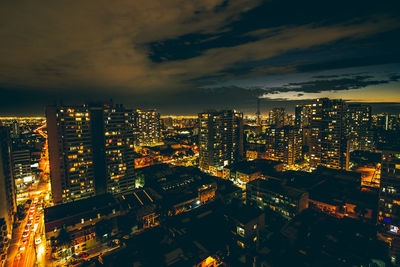 High angle view of illuminated cityscape against sky at night