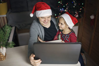 Young woman using laptop at table