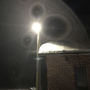 Low angle view of illuminated building against sky at night