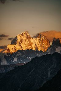 Scenic view of snowcapped mountains against sky during sunset