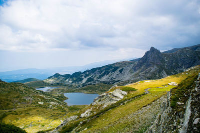 Scenic view of mountains against cloudy sky