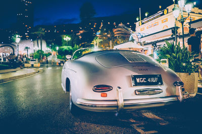 Vintage car on city street at night