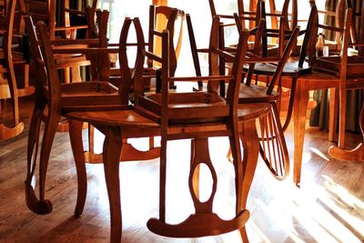 Close-up of chairs on table