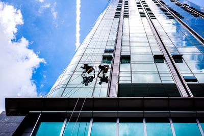 Low angle view of two window cleaners