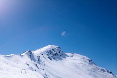 Scenic view of snowcapped mountain against clear blue sky