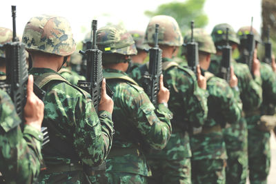 Army soldiers with rifles standing in row