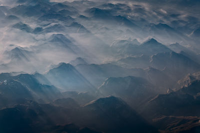 Aerial view of snowcapped mountains against sky