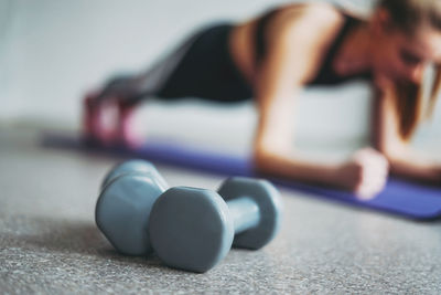 Full length of woman exercising at home