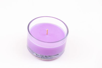 Close-up of pink glass against white background