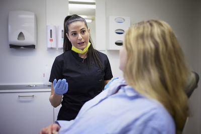 Female dentist with patient in office