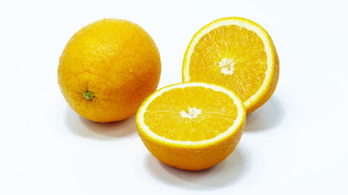 Close-up of orange fruit against white background