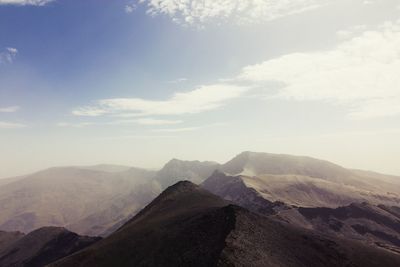 Scenic view of mountain against cloudy sky