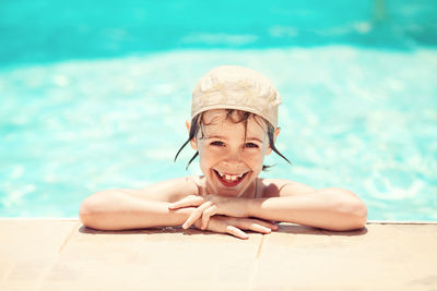 Portrait of happy man sitting in swimming pool