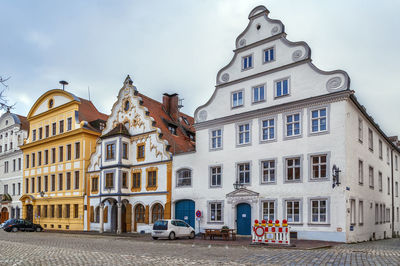 Building by street against sky