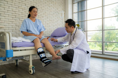 Side view of couple sitting on floor