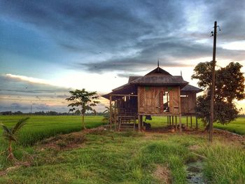 House on field against sky