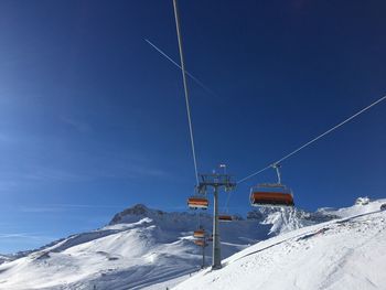 Snow covered mountain against blue sky