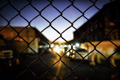 Close-up of chainlink fence against sky