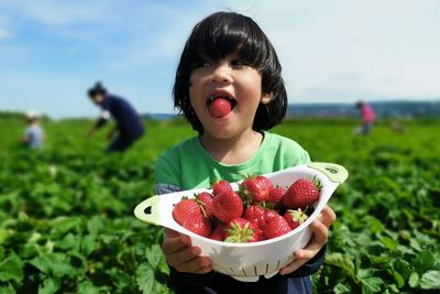 Girl with fruits on field