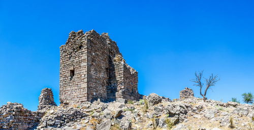 Low angle view of historic building against clear blue sky