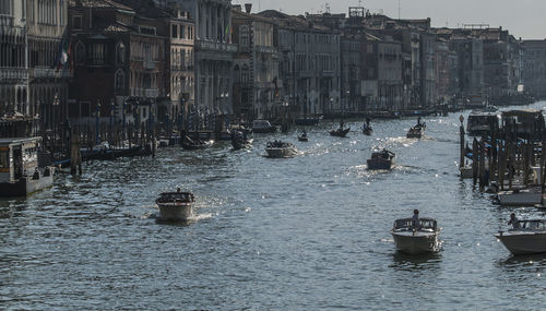 Boats in river with buildings in background