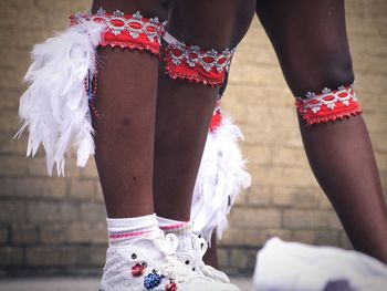 Low section of dancer standing on street during carnival