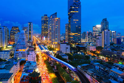 The bangkok skytrain passes through chong non si station a modern office building at thailand