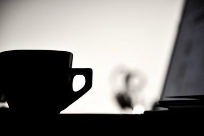 Close-up of hand holding coffee cup