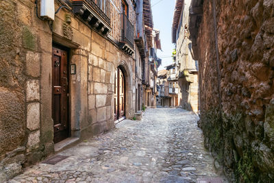 Narrow alley amidst buildings in town