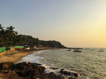 A beach with sunset outside of goa , india