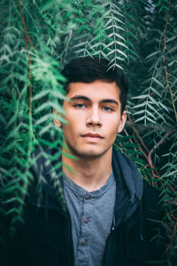 Portrait of young man against plants