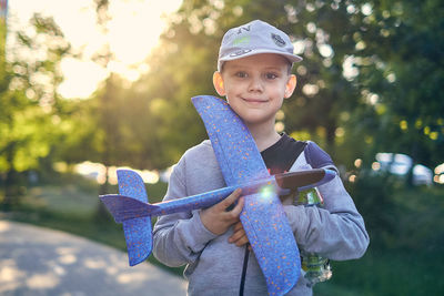 Portrait of smiling boy standing outdoors