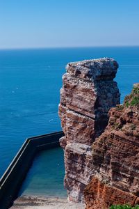 Rock formations by sea against sky