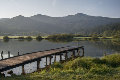 Scenic view of lake and mountains against sky