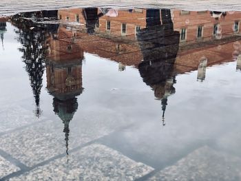 Reflection of building on puddle in lake