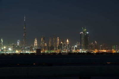 Illuminated city against sky at night