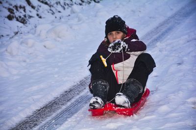 Full length of cute baby girl on snow field during winter