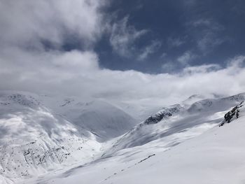 Scenic view of snowcapped mountains against sky