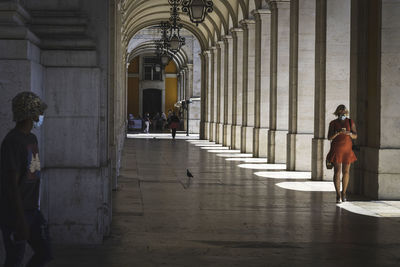 People walking in corridor of building