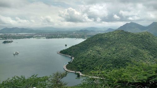 High angle view of sea and mountains against sky