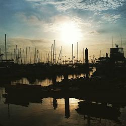 Boats in river at sunset