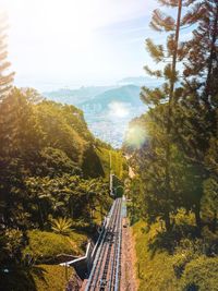 Railroad track on landscape against sky