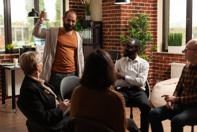 Rear view of people sitting in meeting