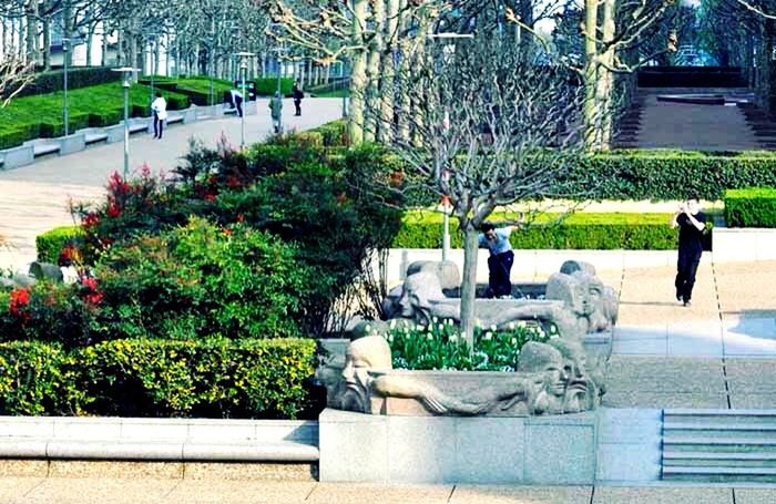 tree, building exterior, statue, park - man made space, sculpture, growth, built structure, architecture, formal garden, plant, fountain, green color, human representation, art and craft, city, lawn, art, garden, flower, creativity