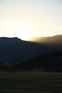 Scenic view of silhouette mountains against sky