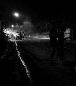 People walking on road at night